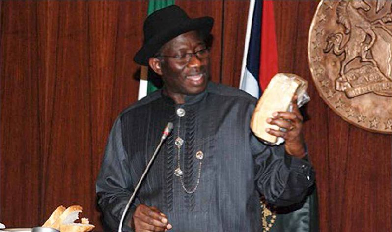 Image result for image of akinwumi adesina holding a cassava bread